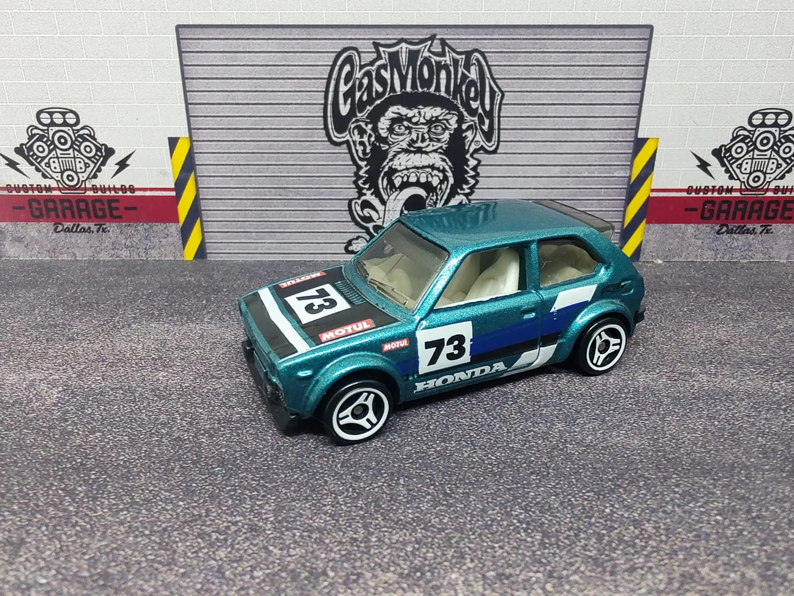 ’73 Honda Civic Custom — turquesa, franjas blancas, número 73