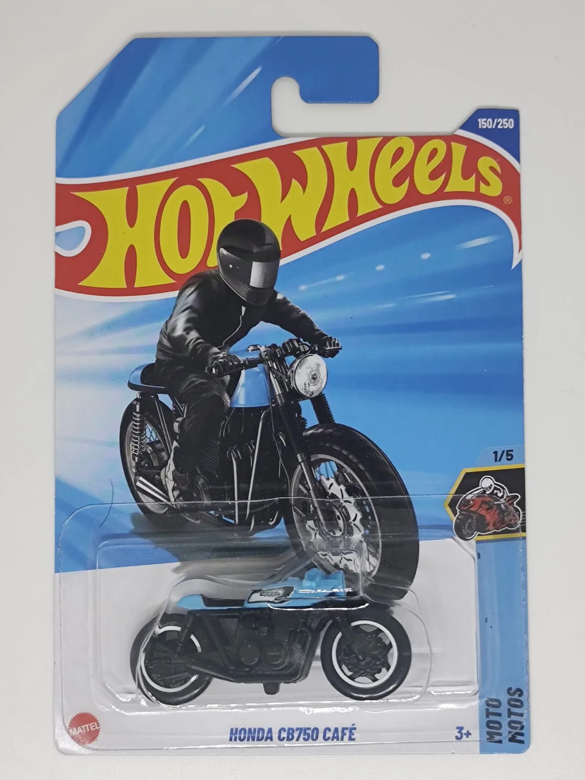 Honda CB750 Café — motocicleta negra y azul con figura de conductor negro