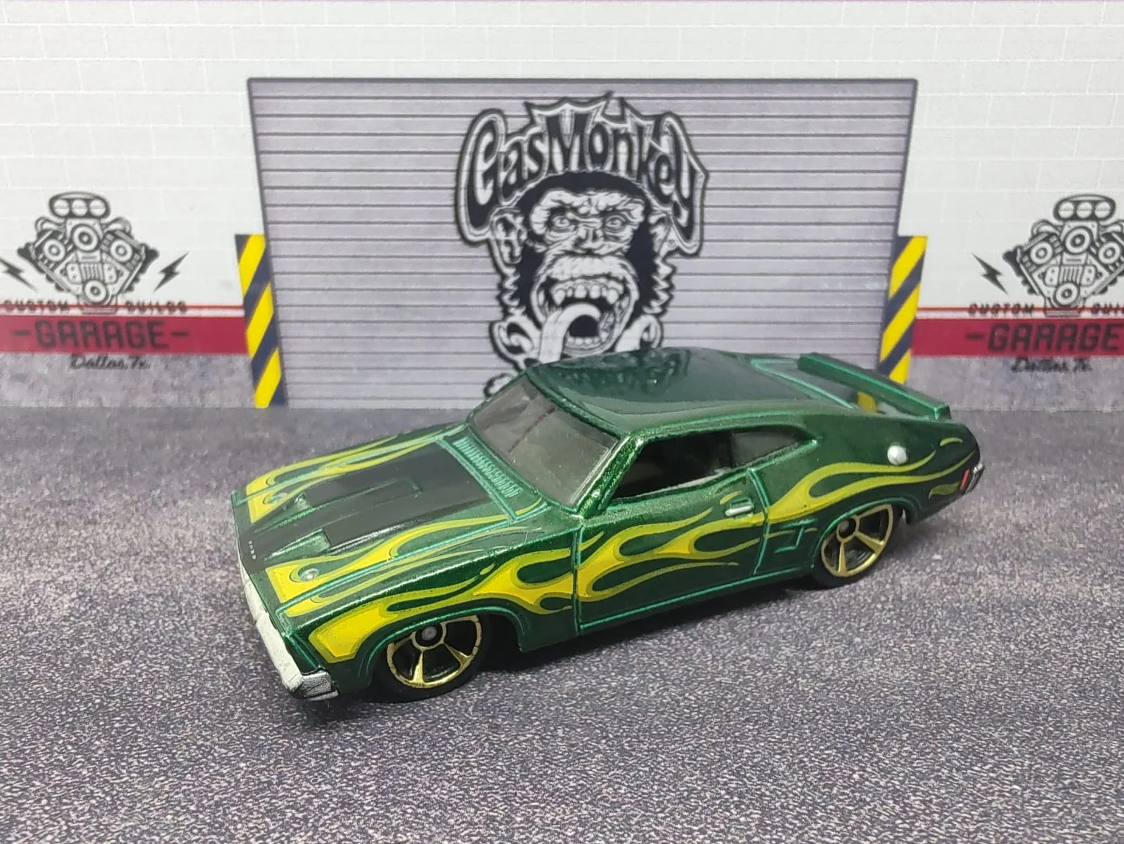 ’73 Ford Falcon XB — verde metalizado con llamas amarillas y llantas de aro dorado
